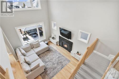 Views from second floor to sun filled living room - 4530 Kelly Farm Drive, Ottawa, ON - Indoor Photo Showing Other Room With Fireplace