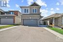 Oversized double laneway with interlock border and synthetic turf - 4530 Kelly Farm Drive, Ottawa, ON  - Outdoor With Facade 