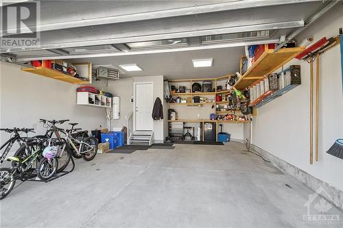 Heated garage will plenty of storage - 4530 Kelly Farm Drive, Ottawa, ON - Indoor Photo Showing Garage