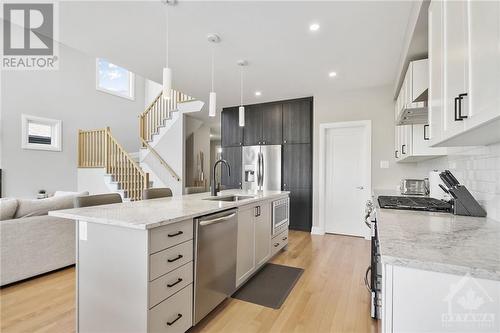 Stainless steel appliances and designer pendants - 4530 Kelly Farm Drive, Ottawa, ON - Indoor Photo Showing Kitchen With Upgraded Kitchen