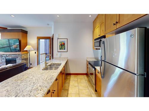 637 A & B - 4559 Timberline Crescent, Fernie, BC - Indoor Photo Showing Kitchen With Fireplace With Stainless Steel Kitchen With Double Sink