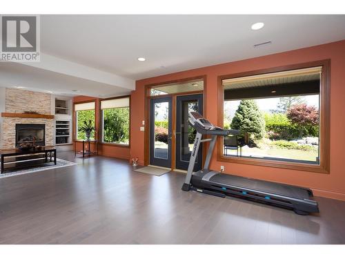 2053 Capistrano Drive, Kelowna, BC - Indoor Photo Showing Gym Room With Fireplace