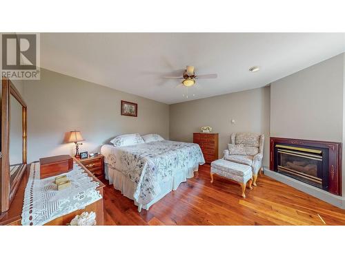 1021 Maple Street, Okanagan Falls, BC - Indoor Photo Showing Bedroom With Fireplace