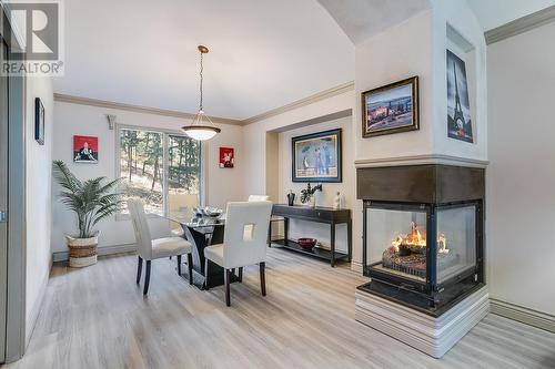 944 Purcell Court, Kelowna, BC - Indoor Photo Showing Dining Room With Fireplace