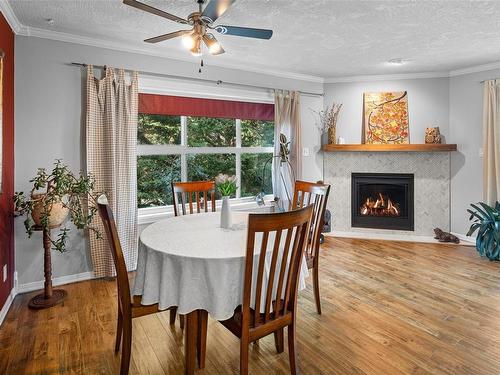 301-1361 Hillside Ave, Victoria, BC - Indoor Photo Showing Dining Room With Fireplace