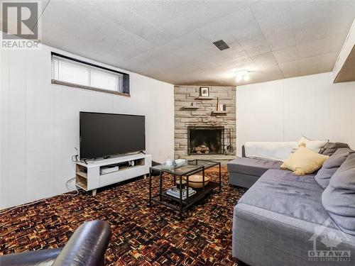 Basement Rec Room - 90 Fieldrow Street, Ottawa, ON - Indoor Photo Showing Living Room With Fireplace