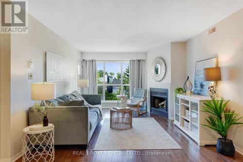 207 - 120 Bell Farm Road, Barrie (Alliance), ON - Indoor Photo Showing Living Room With Fireplace