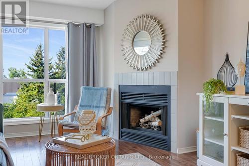 207 - 120 Bell Farm Road, Barrie (Alliance), ON - Indoor Photo Showing Living Room With Fireplace