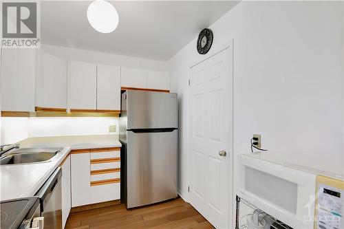 Pantry provides extra storage as well as laundry hookups. Personal items in unit were digitally removed. - 40 Pearl Street Unit#109, Smiths Falls, ON - Indoor Photo Showing Kitchen