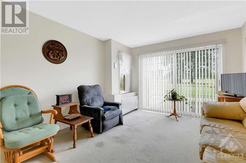 Wall unit is electric and provides heat in winter and a/c in summer. Some personal items were digitally removed. - 40 Pearl Street Unit#109, Smiths Falls, ON - Indoor Photo Showing Living Room