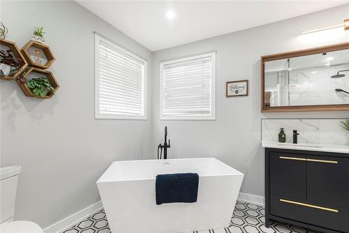 relaxing soaker tub - 54 Stonepine Crescent, Hamilton, ON - Indoor Photo Showing Bathroom