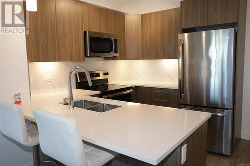 Kitchen with Quartz Counters - 405 3070 Kilpatrick Ave, Courtenay, BC - Indoor Photo Showing Kitchen With Stainless Steel Kitchen With Double Sink With Upgraded Kitchen