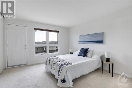 Primary bedroom with large wall to wall closet and balcony - 202 Chapman Mills Drive, Ottawa, ON - Indoor Photo Showing Bedroom