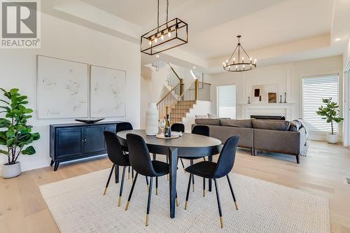 4956 Bucktail Lane, Kelowna, BC - Indoor Photo Showing Dining Room With Fireplace