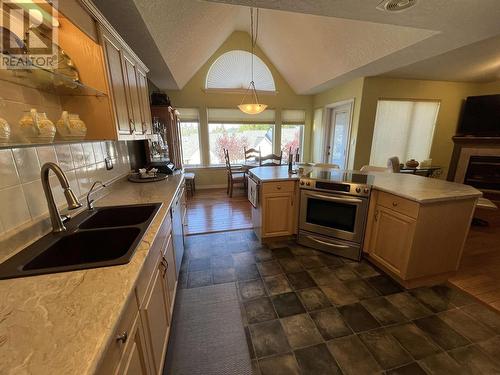 6 11 Eagle Crescent, Williams Lake, BC - Indoor Photo Showing Kitchen With Fireplace With Double Sink