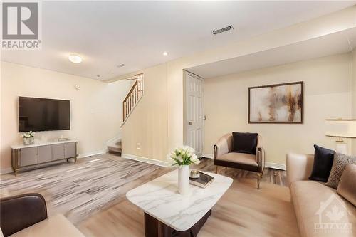 This image has been virtually staged. - 18 Drumso Street, Ottawa, ON - Indoor Photo Showing Living Room