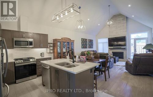 7 - 63 Compass Trail, Central Elgin, ON - Indoor Photo Showing Kitchen With Fireplace With Double Sink With Upgraded Kitchen