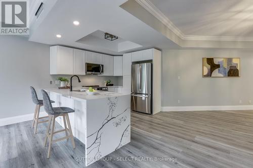 quartz with waterfall edge - 309 - 250 Sydenham Street, London, ON - Indoor Photo Showing Kitchen