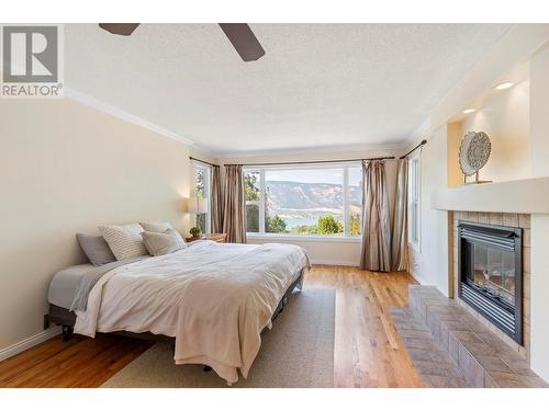 14251 East Hill Road, Lake Country, BC - Indoor Photo Showing Bedroom With Fireplace