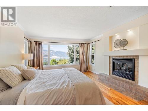 14251 East Hill Road, Lake Country, BC - Indoor Photo Showing Bedroom With Fireplace