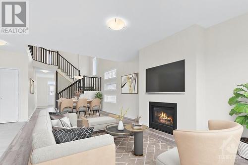 Living and Dining Area (virtually staged) - 129 Seabert Drive, Arnprior, ON - Indoor Photo Showing Living Room With Fireplace