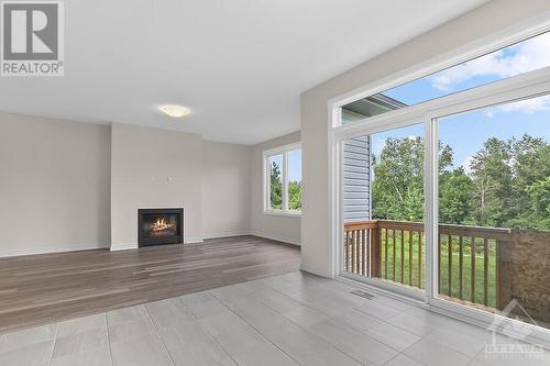 Large oversize patio door off the kitchen to access your back yard - 129 Seabert Drive, Arnprior, ON - Indoor With Fireplace