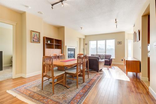 704-1947 Underhill Street, Kelowna, BC - Indoor Photo Showing Dining Room With Fireplace