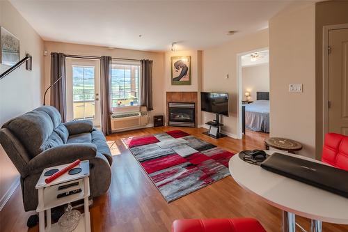 404-7600 Cottonwood Drive, Osoyoos, BC - Indoor Photo Showing Living Room With Fireplace