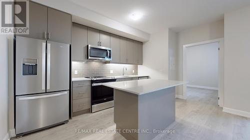 601 - 3220 William Coltson Avenue, Oakville, ON - Indoor Photo Showing Kitchen With Stainless Steel Kitchen With Upgraded Kitchen