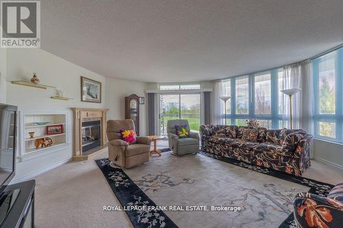 209 - 51 Rivermill Boulevard, Kawartha Lakes (Lindsay), ON - Indoor Photo Showing Living Room With Fireplace