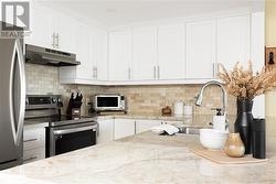 Upgraded countertops, cabinetry & backsplash! - 