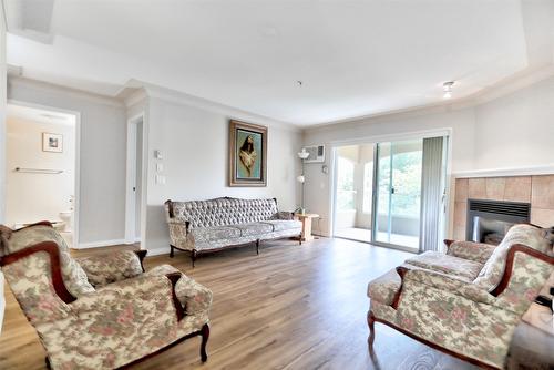 310-1966 Enterprise Way, Kelowna, BC - Indoor Photo Showing Living Room With Fireplace