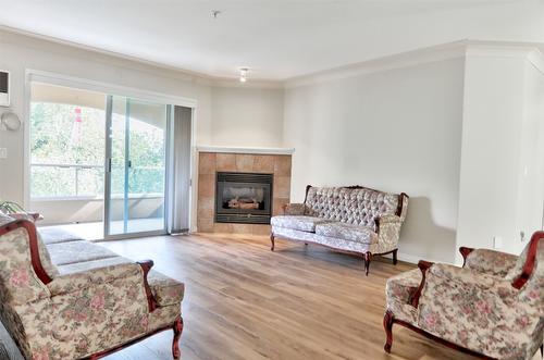 310-1966 Enterprise Way, Kelowna, BC - Indoor Photo Showing Living Room With Fireplace