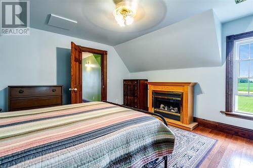 1612 County Rd 8, Leamington, ON - Indoor Photo Showing Bedroom With Fireplace