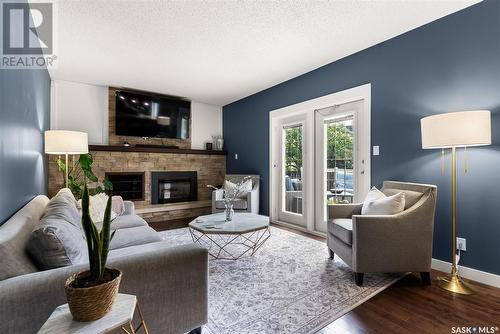 2034 Braun Bay E, Regina, SK - Indoor Photo Showing Living Room With Fireplace