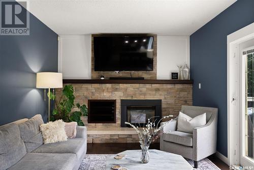 2034 Braun Bay E, Regina, SK - Indoor Photo Showing Living Room With Fireplace