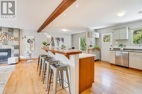 1264 Rio Drive, Kelowna, BC - Indoor Photo Showing Kitchen With Fireplace