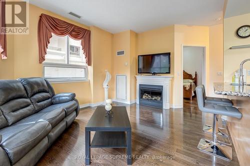 209 - 350 Princess Royal Drive, Mississauga (City Centre), ON - Indoor Photo Showing Living Room With Fireplace