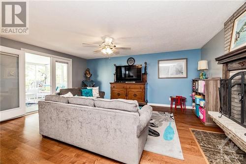 Family room has large patio doors going out to a 3 season sunroom - 211 Park Avenue, Carleton Place, ON - Indoor Photo Showing Living Room With Fireplace