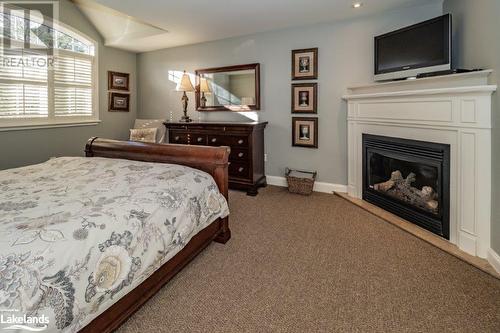 3876 Muskoka 118 Highway W Unit# Carling 3 Week 9, Port Carling, ON - Indoor Photo Showing Bedroom With Fireplace