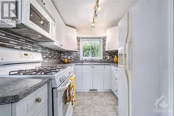 There’s lots of cupboards and counter space in this kitchen. Gas stove too, so even with power outages you can use the stove top. - 