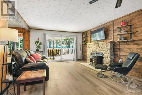 Spacious living room with cozy pellet stove - 889 Jones Point Road, Perth, ON - Indoor Photo Showing Living Room With Fireplace