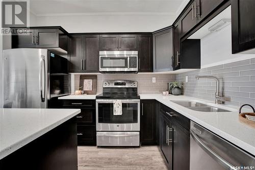 110 545 Hassard Close, Saskatoon, SK - Indoor Photo Showing Kitchen With Stainless Steel Kitchen With Double Sink With Upgraded Kitchen