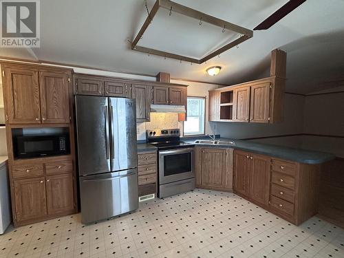 16 5701 Airport Drive, Fort Nelson, BC - Indoor Photo Showing Kitchen With Double Sink