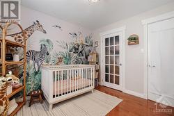 Another view of the second bedroom.  Please note that the art is peel & stick wallpaper and it will be removed prior to closing. - 