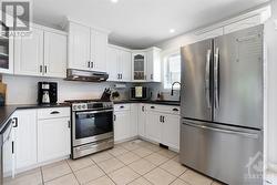 LOADS of cupboards and counter space in this kitchen!  Note the newer gleaming appliances! - 