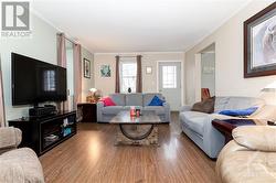 Another view of the living room showing the front door & access to the dining room - 