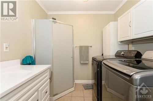 Full shower in the main floor bath/laundry room!  So handy on gardening days! - 1560 South Mcnaughton Road, Admaston, ON - Indoor Photo Showing Laundry Room