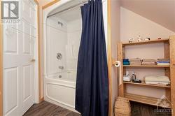 Upper level full bathroom with storage - 