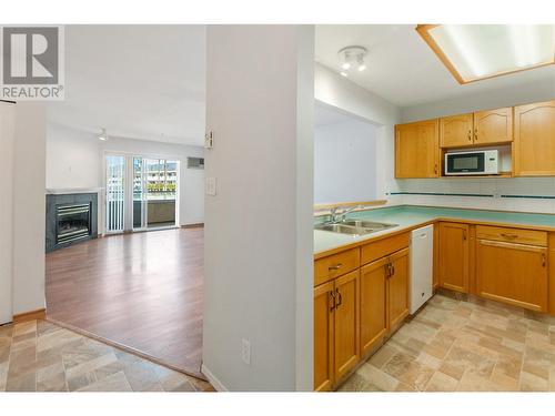 2401 South Main Street Unit# 202, Penticton, BC - Indoor Photo Showing Kitchen With Fireplace With Double Sink